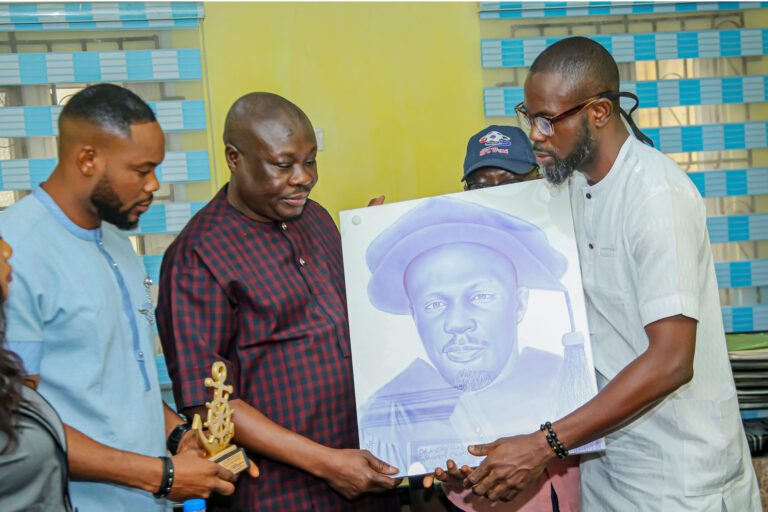 Engr. Iseru NMU delegation team lead, presenting portrait of Tompolo to Dr. Paul Bebenimibo