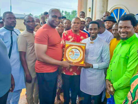 Chief Ogbuku receiving Badge of Honour presented by Comrade Johnny Jonathan