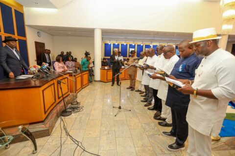 Governor Sim and the new chairmen as they take oath of office.