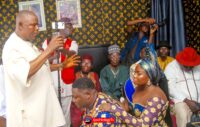 The couple Chief and Mrs Benjamin Ekeremor being prayed for and receiving father blessings from the bride's father