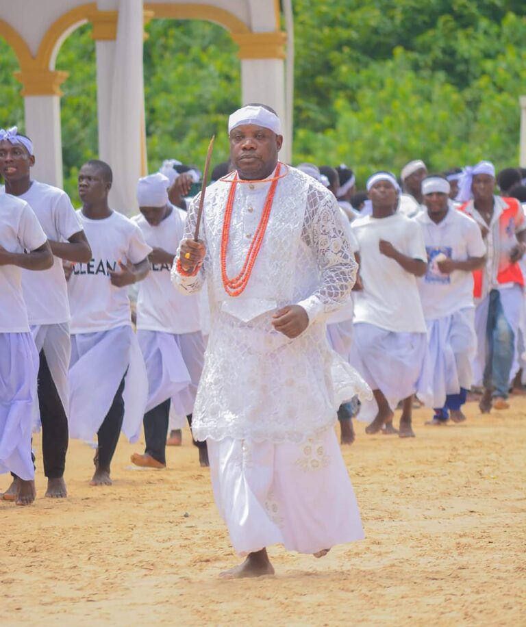 Dr Dennis Otuaro performing a religious prayer ritual known as Owei-gbele at the sacred Gbaraun Egbesu Temple in Oporoza