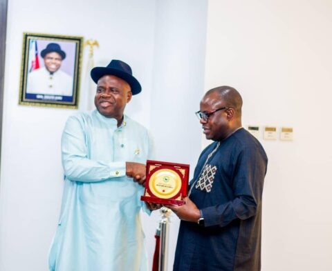 The Administrator of the Presidential Amnesty Programme Dr Dennis Otuaro presenting a souvenir to Bayelsa Governor Douye Diri