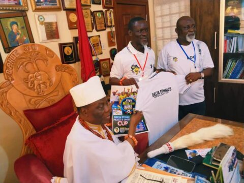 National Coordinator of CEPEJ, Chief Sheriff Mulade, and the LOC chairman, Hon. Kenneth Nwaomucha, presenting a jersey to HRM during the official visit to the palace at the headquarters of Okpe LGA on Monday.