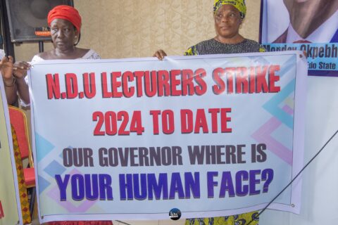 Mothers holding banners with inscriptions