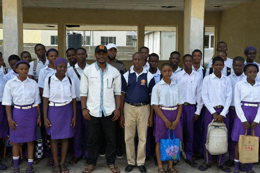 Mc Senibo with some of the benefiting students 